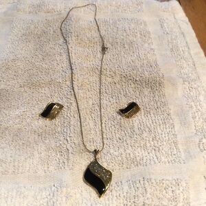Black and gold jewelry set containing necklace and matching earrings